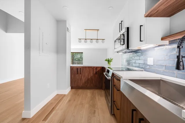 a kitchen with a sink stove and microwave