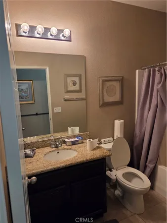 a white toilet sitting next to a shower curtain