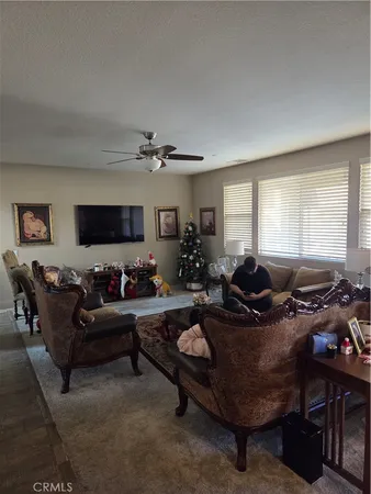 a bedroom with a bed a dresser next to a window