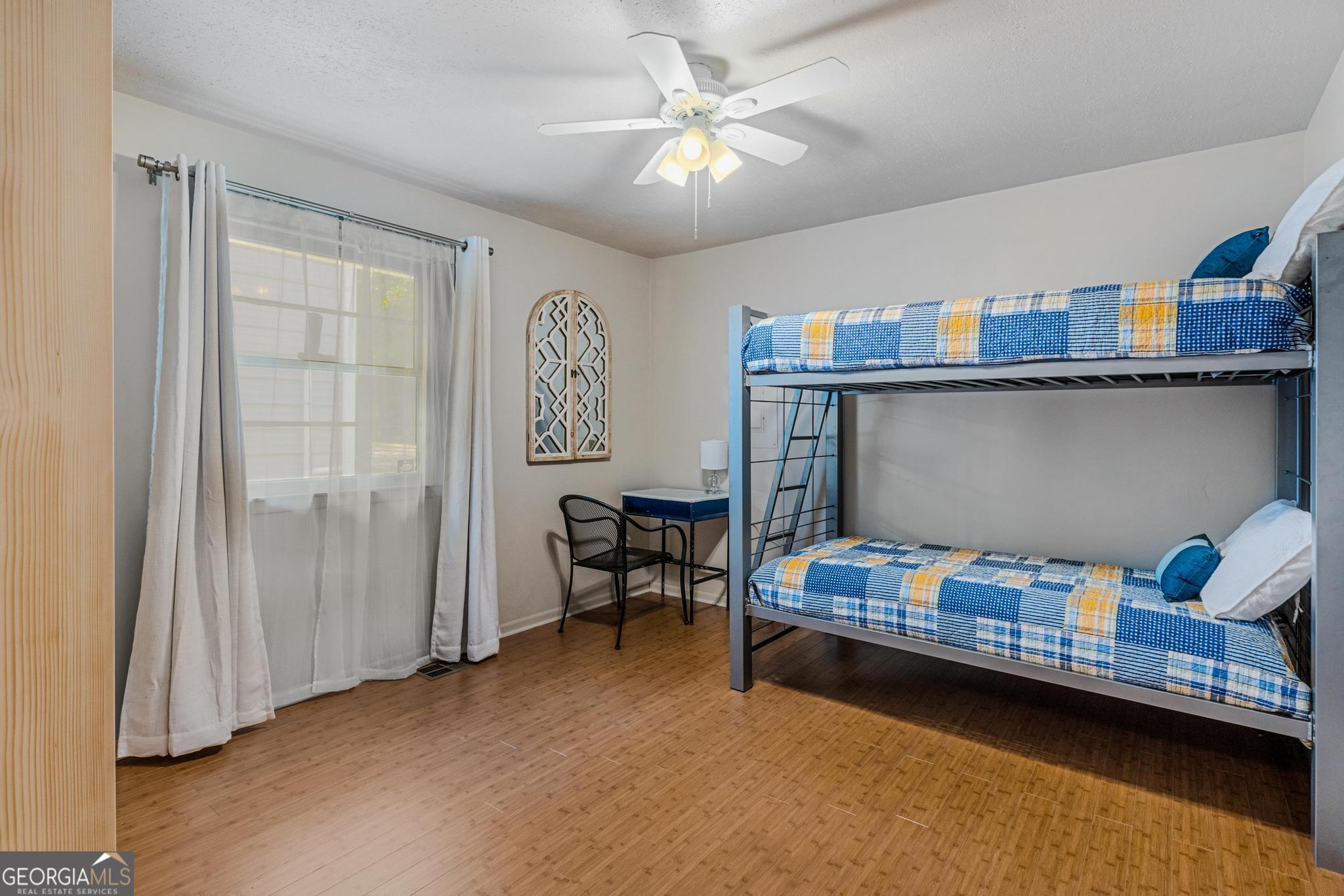 136 Yancey Road Jackson, GA 30233 - Photo 19 of 37 a bedroom with furniture and a chandelier