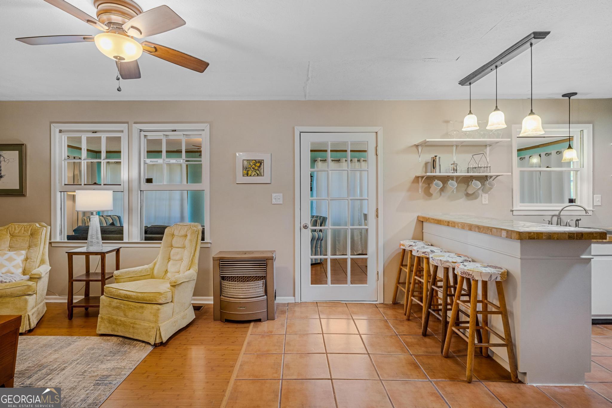 136 Yancey Road Jackson, GA 30233 - Photo 22 of 37 a living room with furniture a dining table and a chandelier