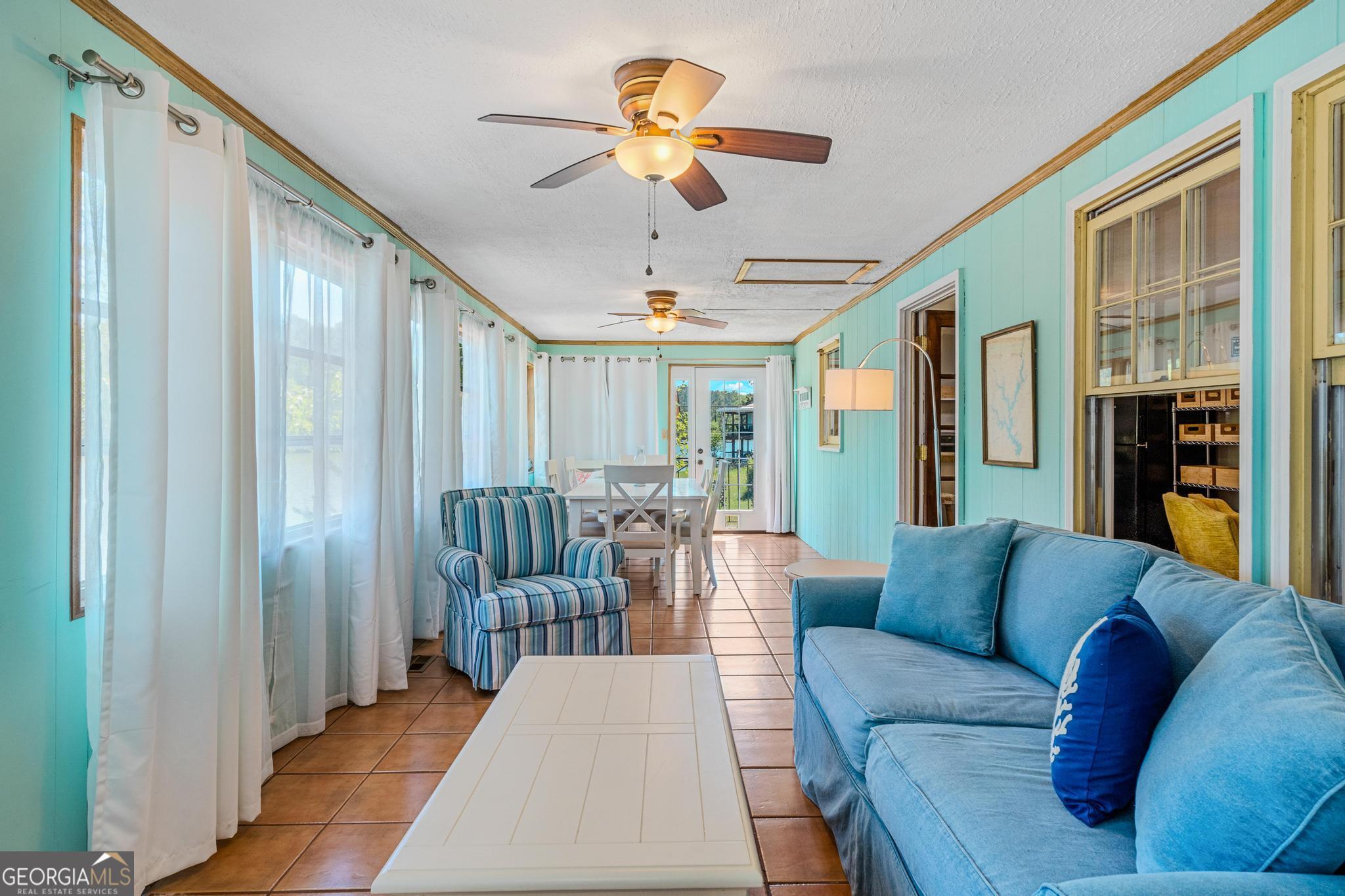 136 Yancey Road Jackson, GA 30233 - Photo 25 of 37 a living room with furniture ceiling fan and a rug