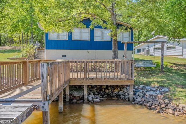 an aerial view of residential house with outdoor space and lake view