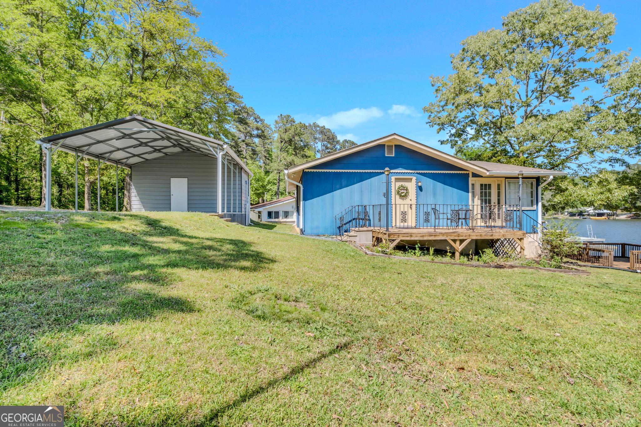 136 Yancey Road Jackson, GA 30233 - Photo 4 of 37 a front view of a house with a garden and porch