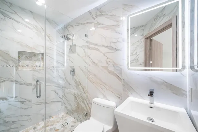 a bathroom with a sink toilet and shower