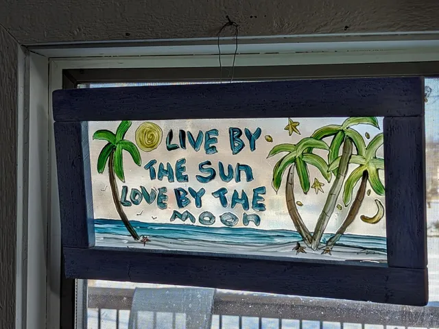 a group of people sitting in front of retail shops