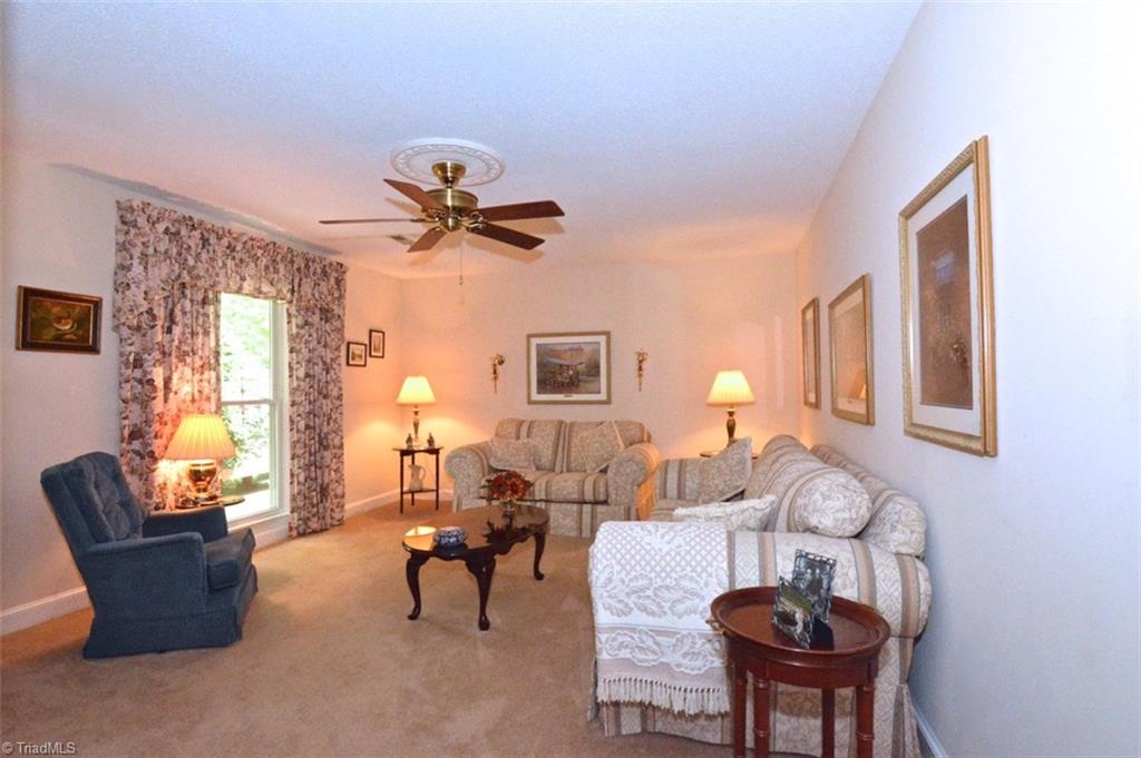 109 Mersey Road Greensboro, NC 27406 - Photo 13 of 28 This is the formal living room...rarely used but spacious and light filled. The font door is located here but folks prefer to come in through the sunroom door. The whole home is on an alarm system but this is a very safe area.