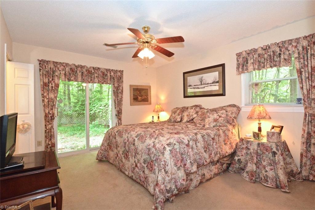 109 Mersey Road Greensboro, NC 27406 - Photo 15 of 28 The master suite is on the back of the home with dual doors to the rear yard. It has a totally remodeled bath.