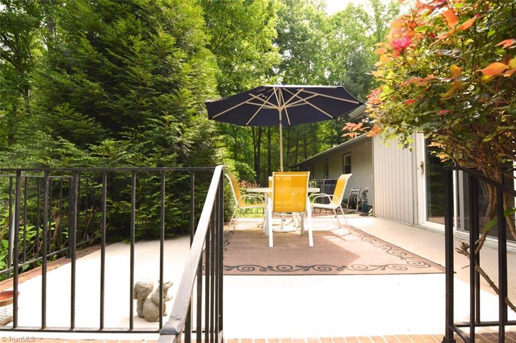 109 Mersey Road Greensboro, NC 27406 - Photo 23 of 28 Lovely raised patio is surrounded by wrought iron railing and is off the rear of the home.