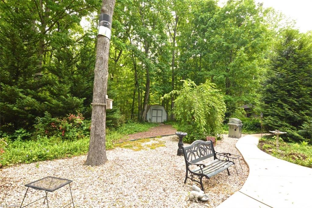109 Mersey Road Greensboro, NC 27406 - Photo 25 of 28 Walkways are found everywhere! A storage shed also comes with the property.