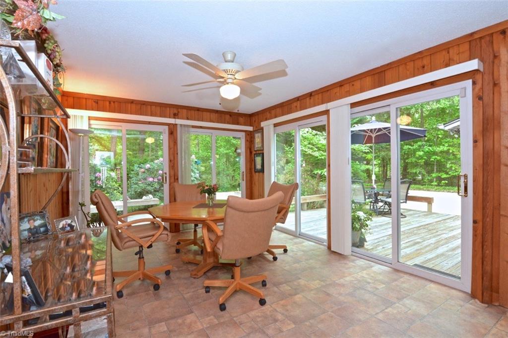 109 Mersey Road Greensboro, NC 27406 - Photo 5 of 28 Mealtime is wonderful overlooking this enchanting wrap around deck. The floors while appearing to be tile are high-end vinyl. You have to feel them to believe it! Much easier to maintain.