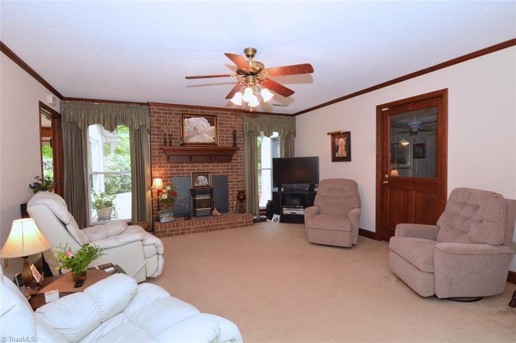 109 Mersey Road Greensboro, NC 27406 - Photo 8 of 28 Just a few steps from the sunroom is the family room or den with its wood burning fireplace with pellet stove. These stoves really put out the heat and are very easy to use with just a few small pellets!!!