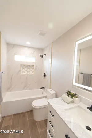 a bathroom with a sink a toilet and a bathtub