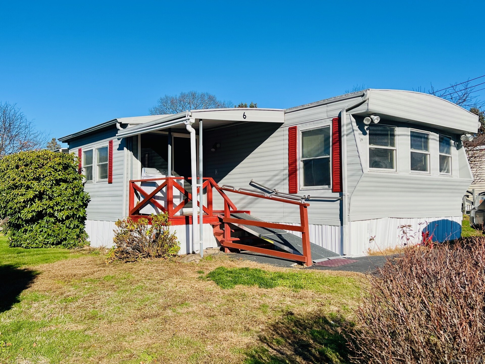 a view of a wooden house with a yard