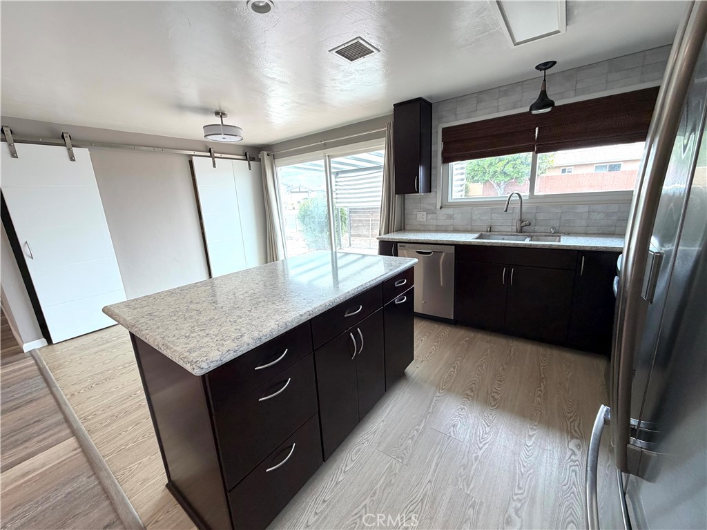 8657 Rumson Drive Santee, CA 92071 - Photo 17 of 65 a large kitchen with a sink a large window and stainless steel appliances