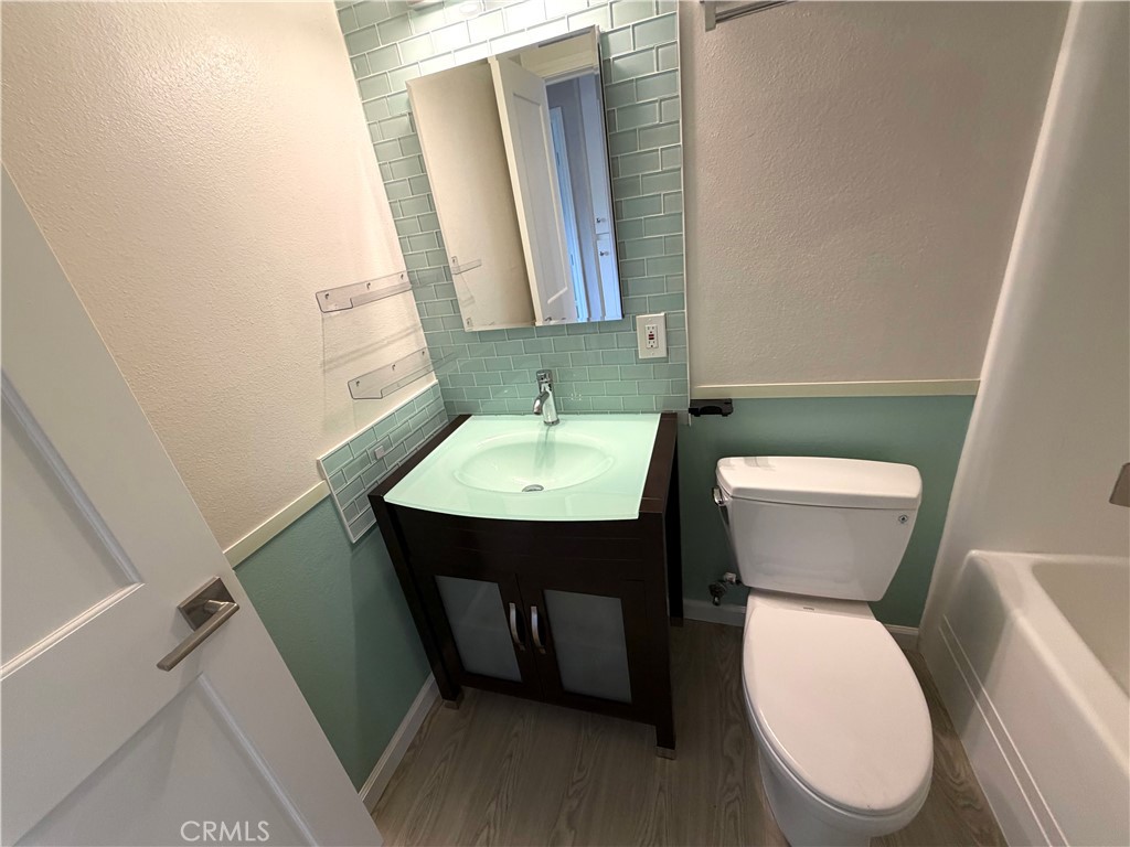 8657 Rumson Drive Santee, CA 92071 - Photo 26 of 65 a bathroom with a toilet sink and mirror