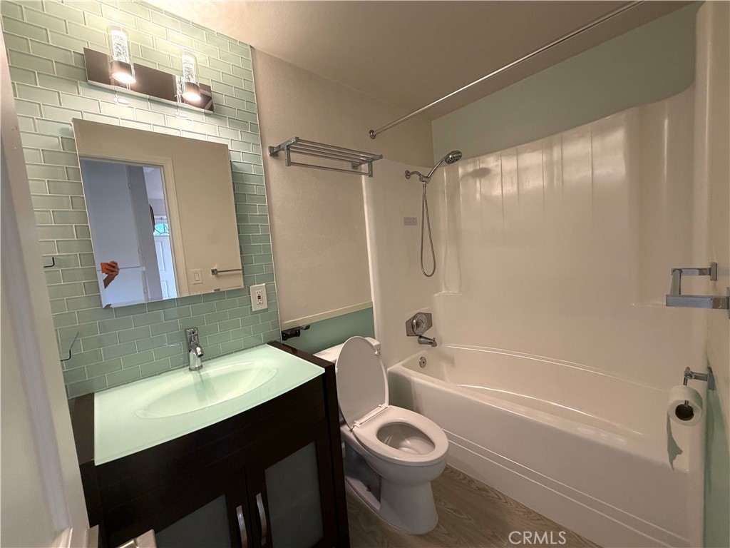 8657 Rumson Drive Santee, CA 92071 - Photo 28 of 65 a bathroom with a sink a toilet a mirror a bathtub and shower