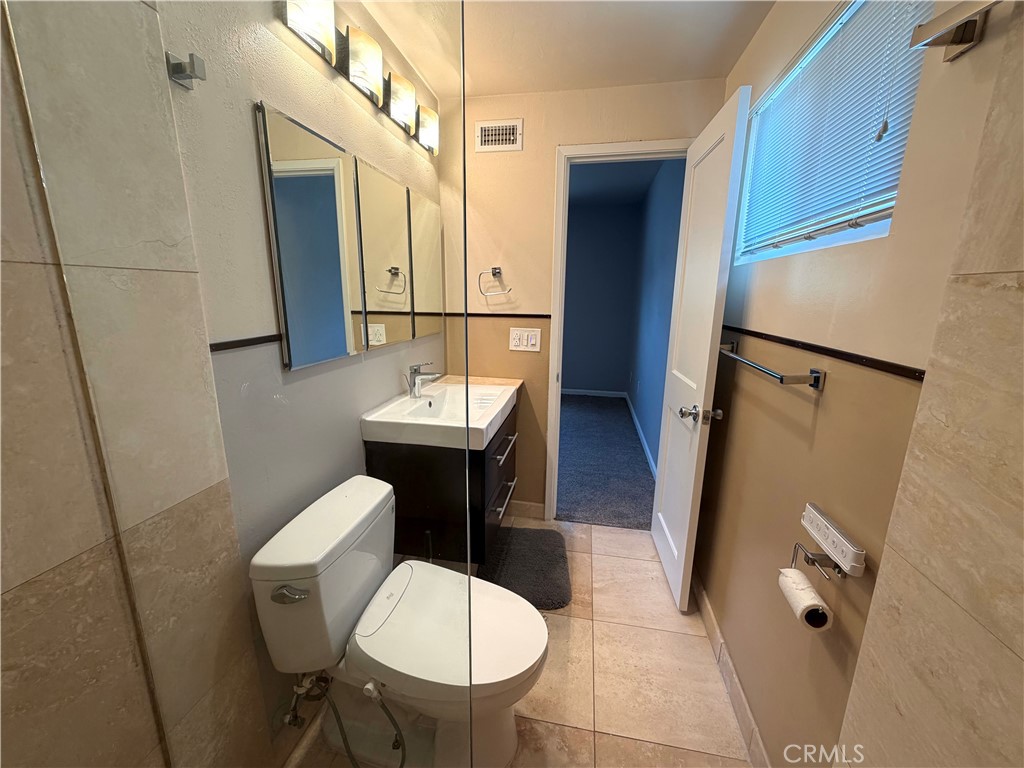 8657 Rumson Drive Santee, CA 92071 - Photo 29 of 65 a bathroom with a sink toilet and mirror
