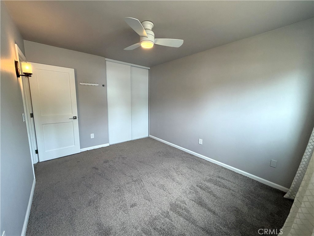 8657 Rumson Drive Santee, CA 92071 - Photo 32 of 65 an empty room with a window and a ceiling fan