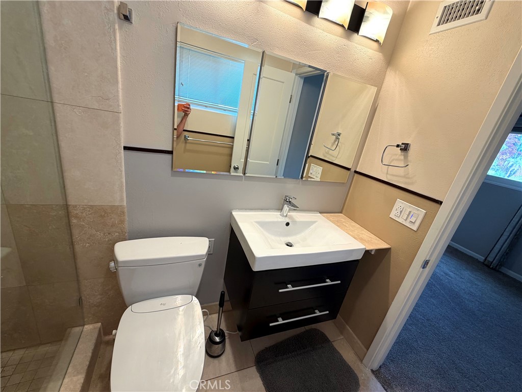 8657 Rumson Drive Santee, CA 92071 - Photo 34 of 65 a bathroom with a toilet a sink and mirror