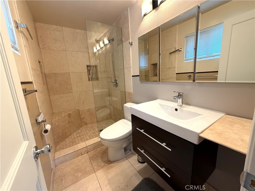8657 Rumson Drive Santee, CA 92071 - Photo 37 of 65 a bathroom with a sink toilet a mirror and shower