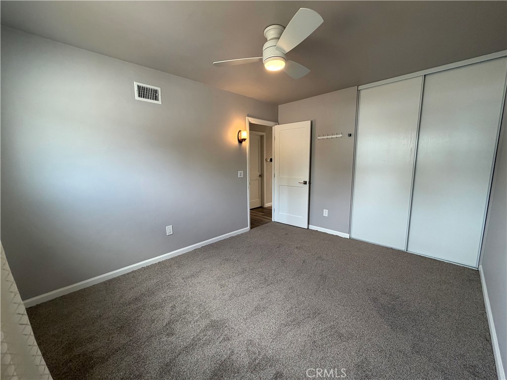 8657 Rumson Drive Santee, CA 92071 - Photo 40 of 65 an empty room with a ceiling fan and a bathroom