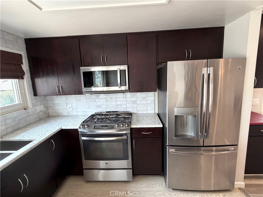 8657 Rumson Drive Santee, CA 92071 - Photo 9 of 65 a kitchen with a refrigerator stove and microwave
