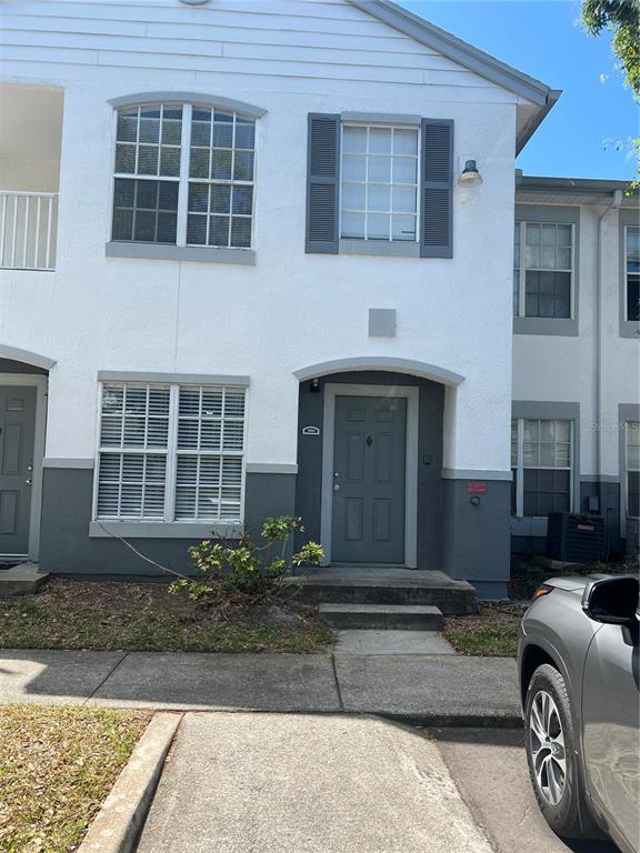 4312 South Kirkman Road, Unit 1404 Orlando, FL 32811 - Photo 1 of 5 a front view of a house with a yard