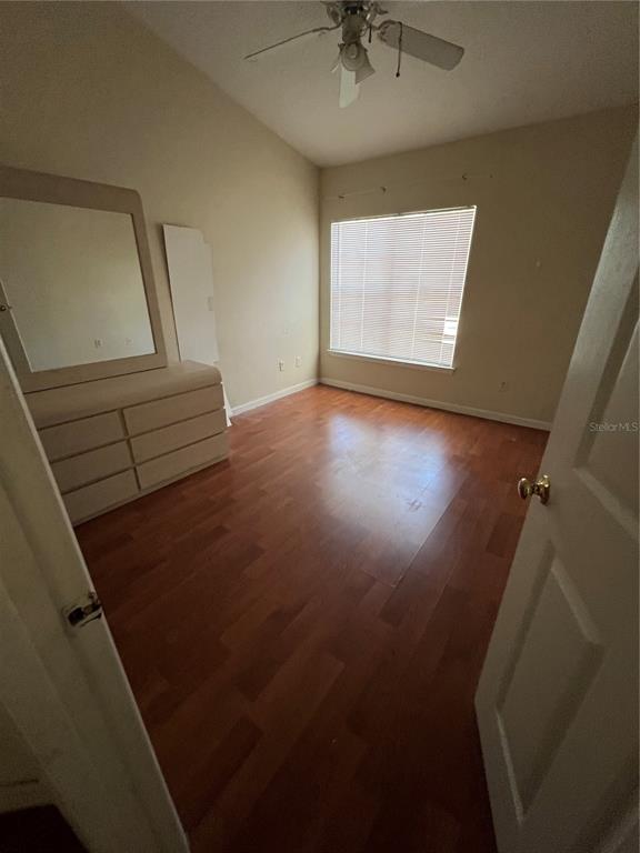 4312 South Kirkman Road, Unit 1404 Orlando, FL 32811 - Photo 5 of 5 wooden floor in an empty room with a window