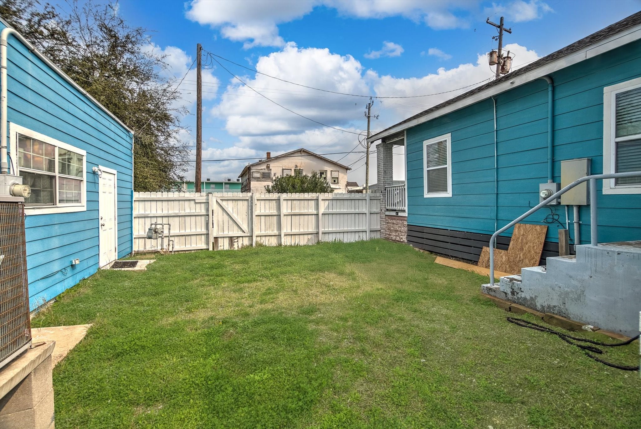 905 43rd Street Galveston, TX 77550 - Photo 43 of 43 Charming backyard with a well-maintained lawn, and privacy fence. Great potential for outdoor activities or gardening.