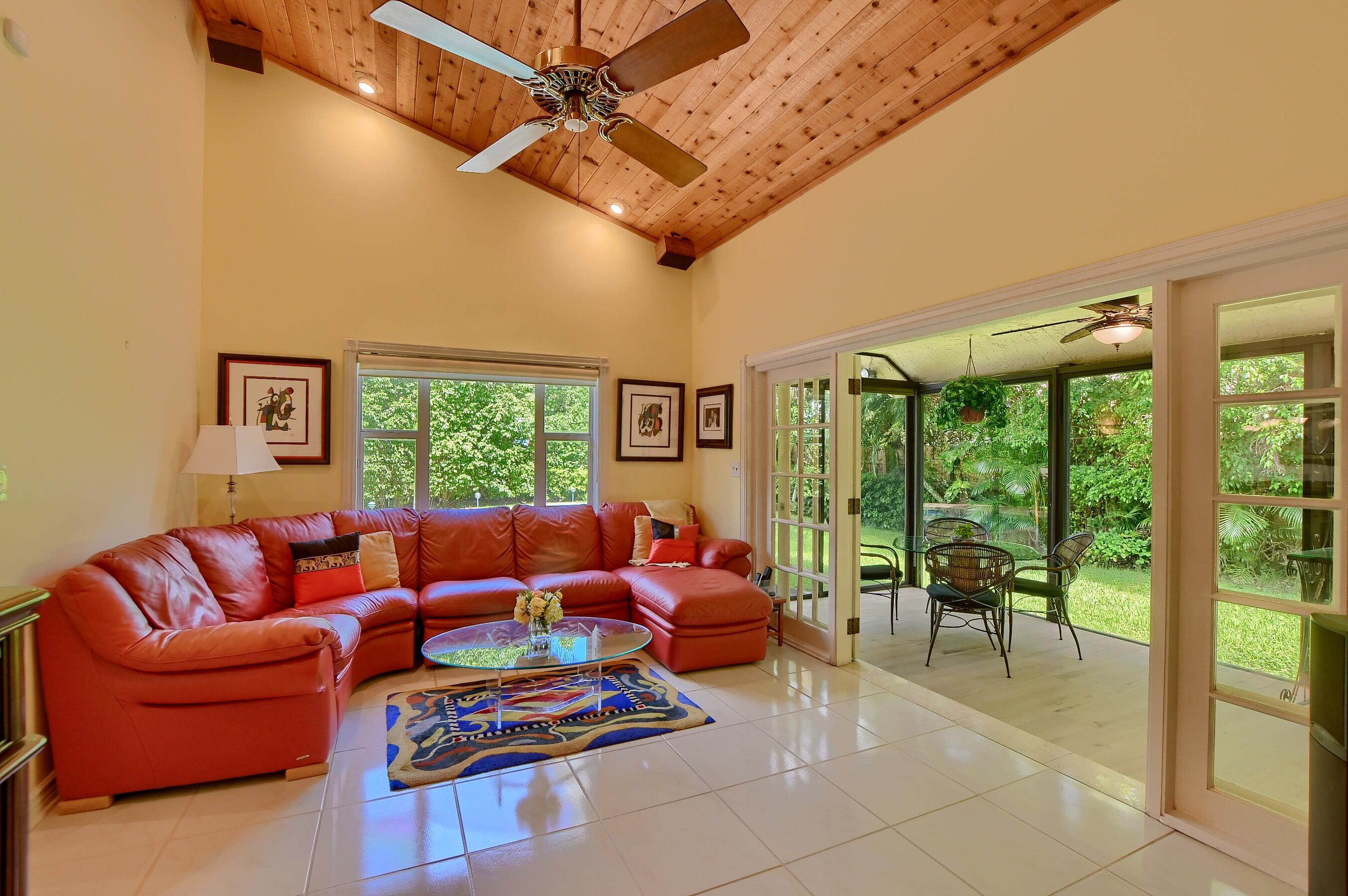 2845 Northwest 42nd Street Boca Raton, FL 33434 - Photo 17 of 60 a living room with furniture a ceiling fan and a large window