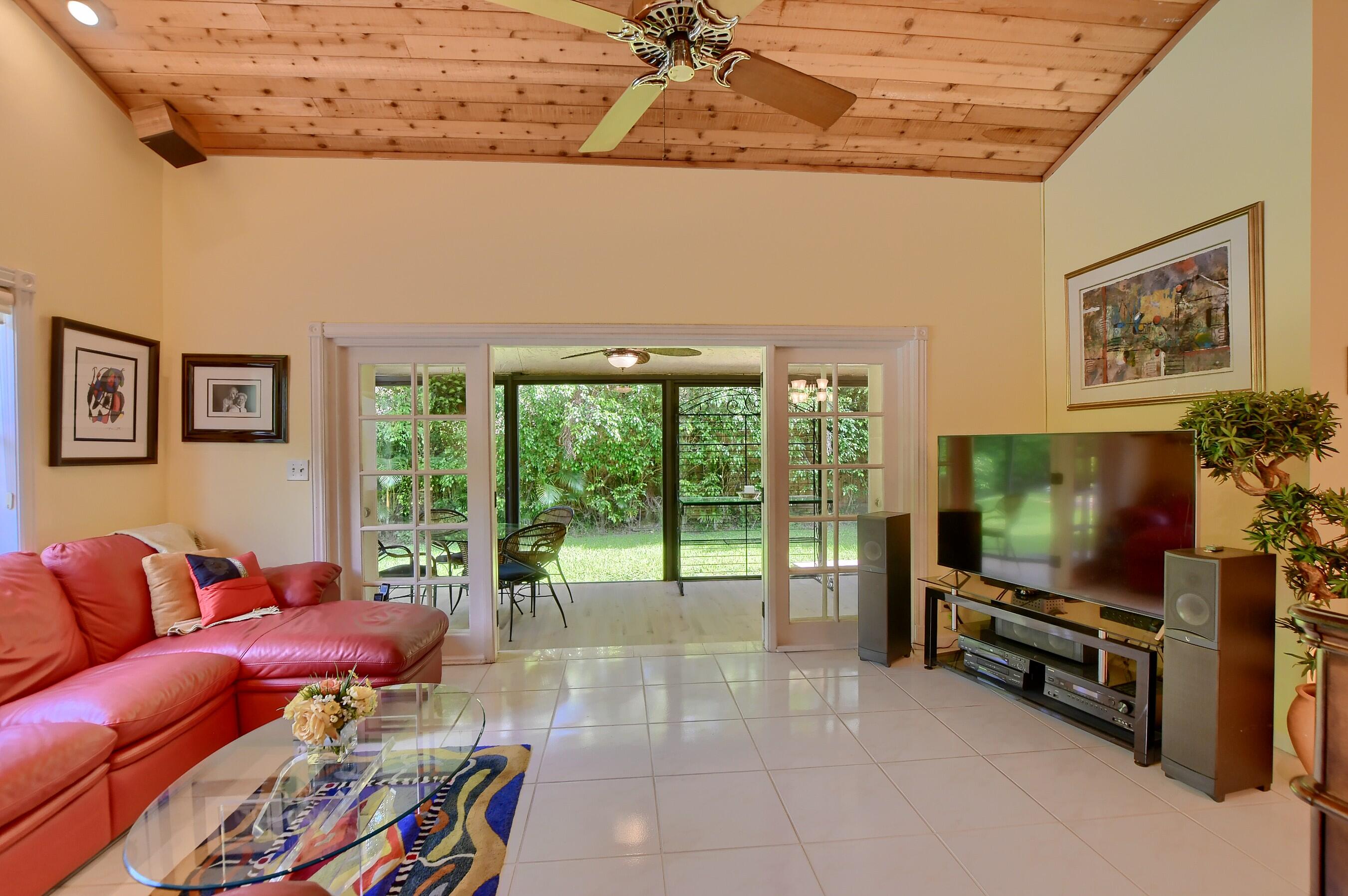 2845 Northwest 42nd Street Boca Raton, FL 33434 - Photo 18 of 60 a living room with furniture and a flat screen tv
