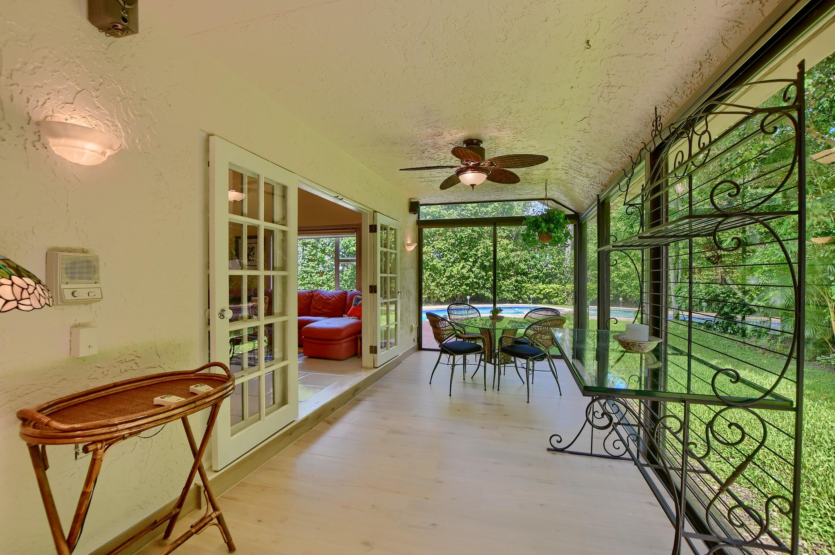 2845 Northwest 42nd Street Boca Raton, FL 33434 - Photo 21 of 60 a dining room with furniture and a floor to ceiling window