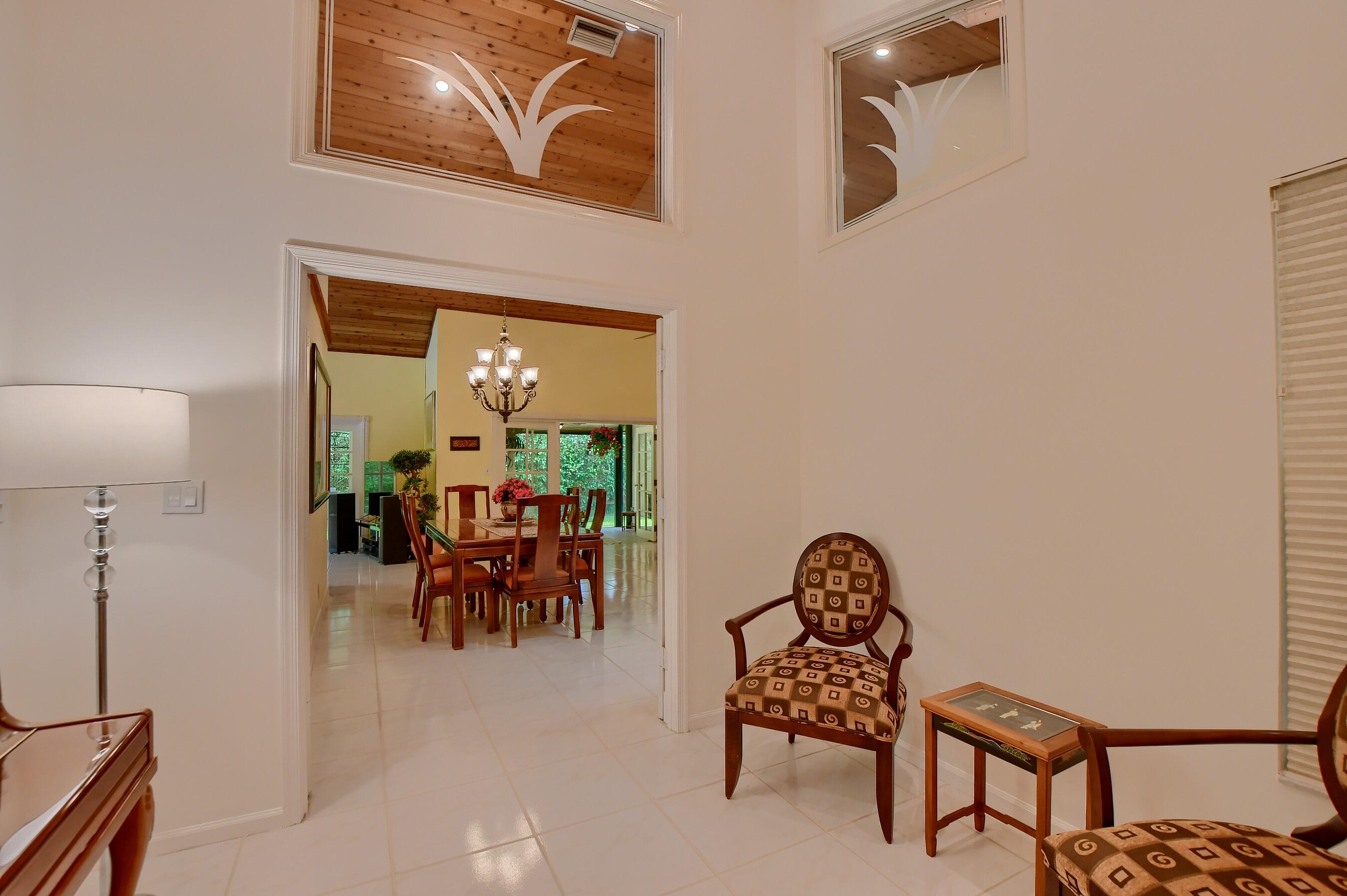 2845 Northwest 42nd Street Boca Raton, FL 33434 - Photo 27 of 60 a living room with furniture and a chandelier