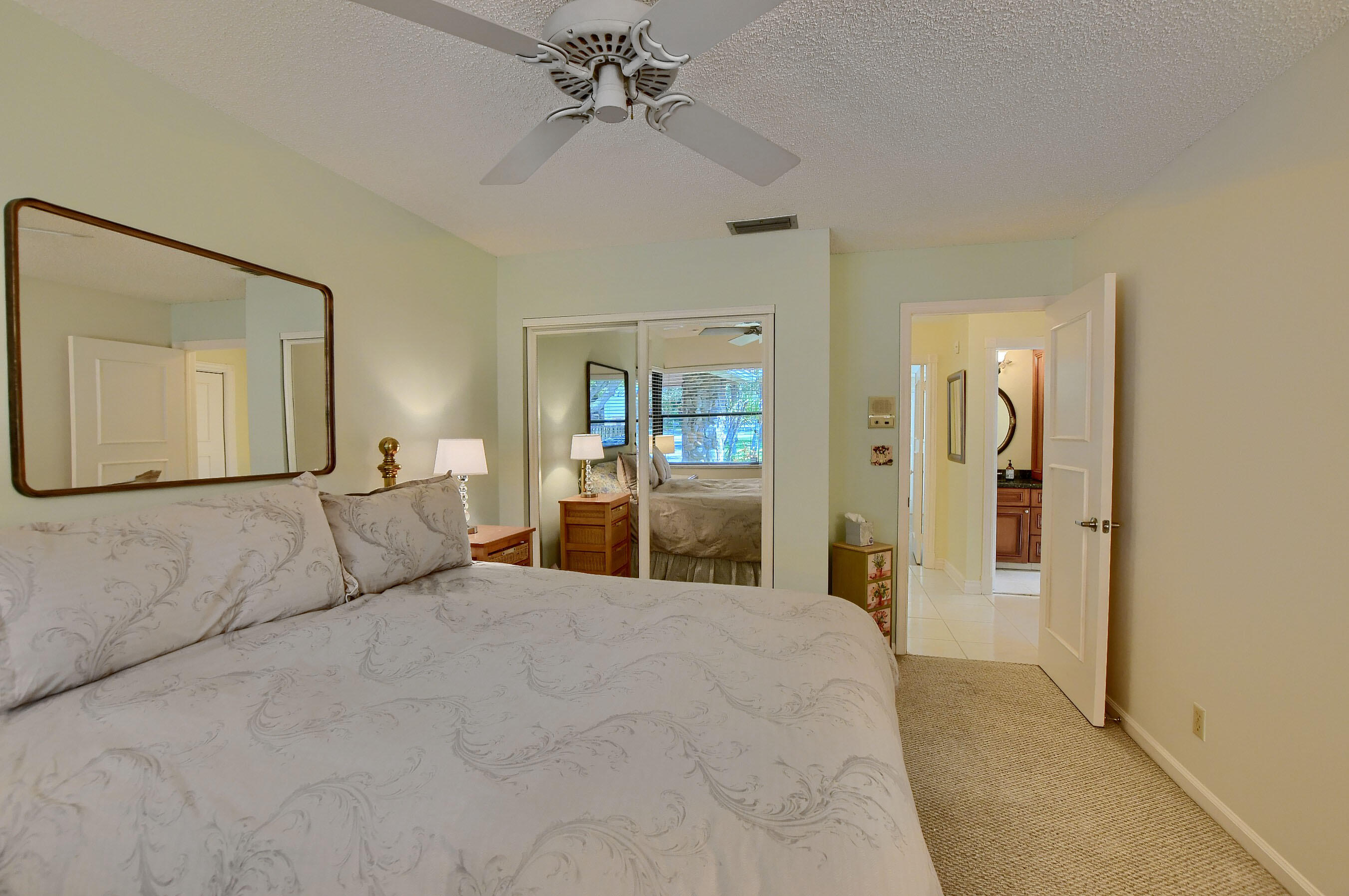 2845 Northwest 42nd Street Boca Raton, FL 33434 - Photo 39 of 60 a bedroom with a large bed and a chandelier