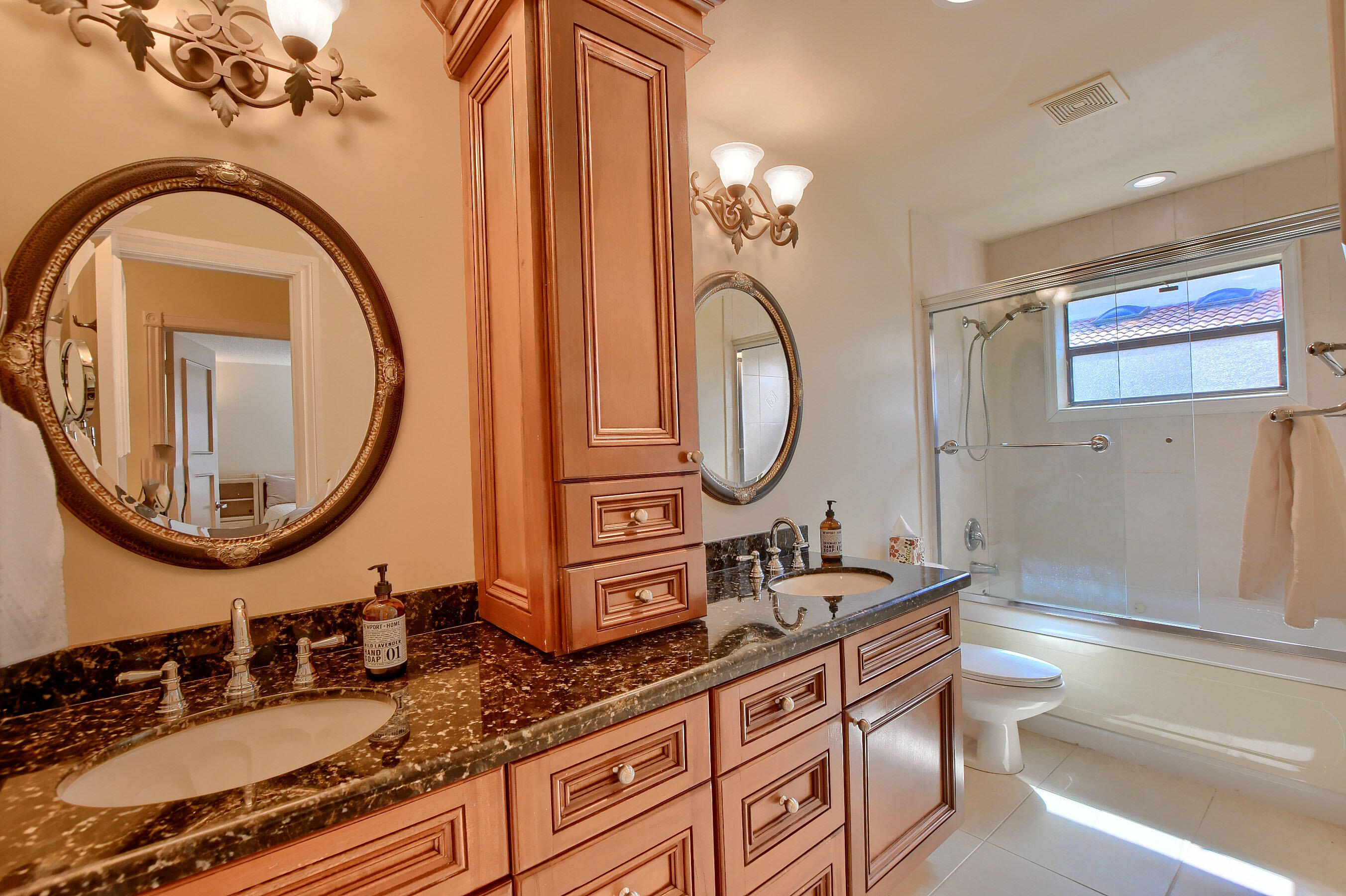 2845 Northwest 42nd Street Boca Raton, FL 33434 - Photo 40 of 60 a bathroom with a double vanity sink and a mirror