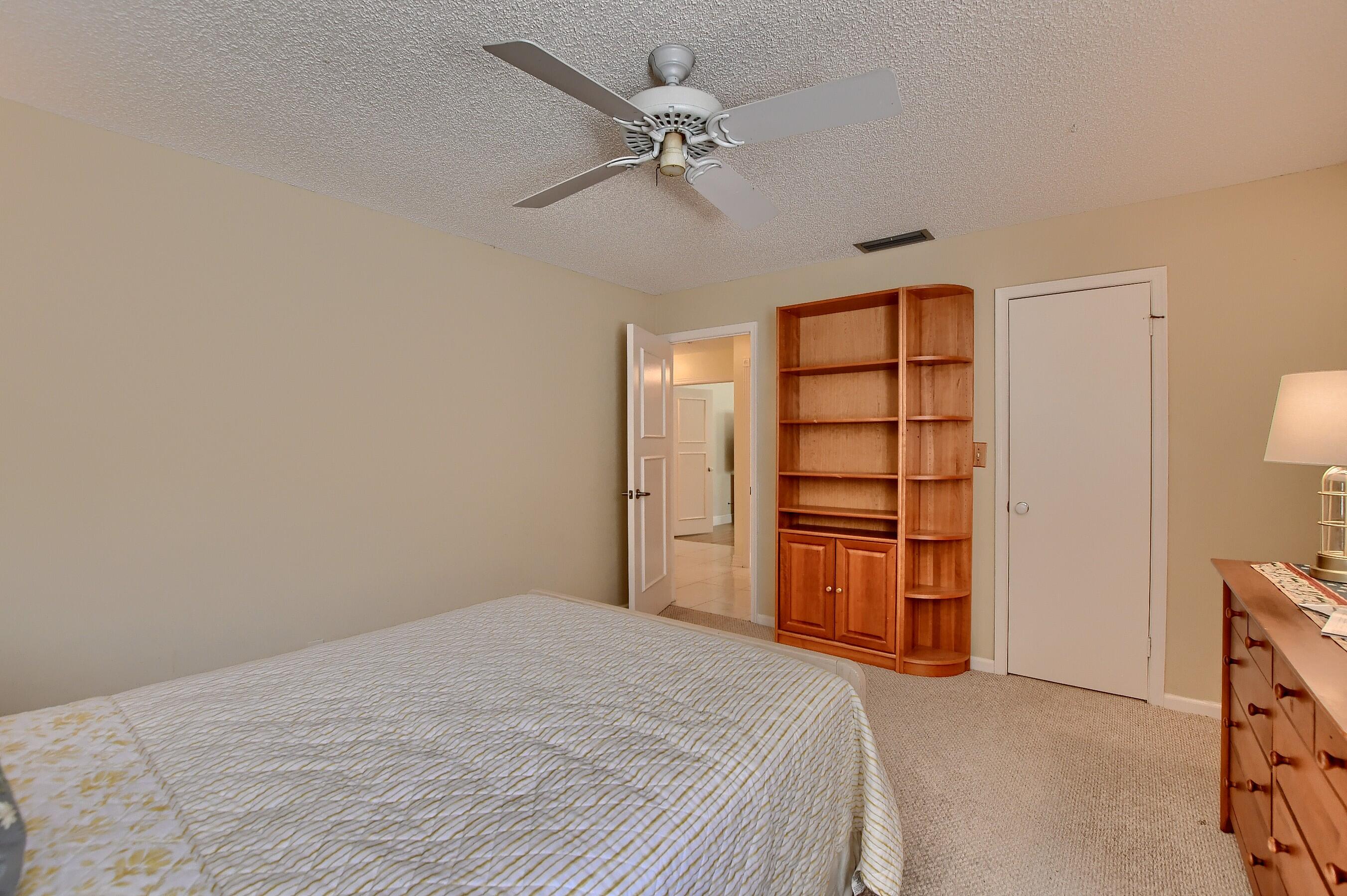 2845 Northwest 42nd Street Boca Raton, FL 33434 - Photo 42 of 60 a bedroom with a bed dresser and a window