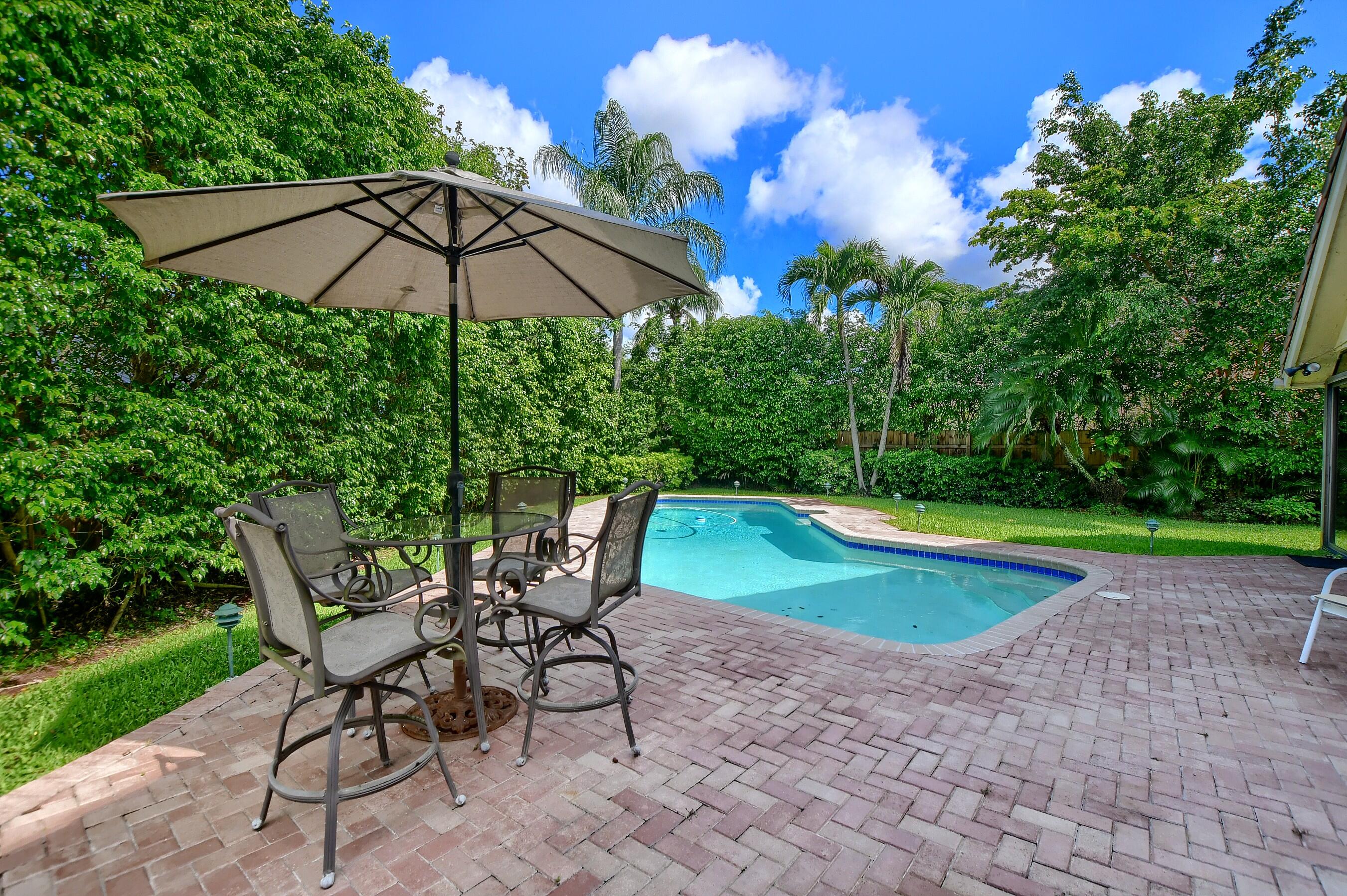 2845 Northwest 42nd Street Boca Raton, FL 33434 - Photo 45 of 60 a view of a table and chairs under an umbrella