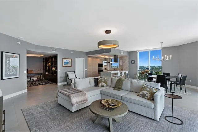 a living room with furniture kitchen view and a table