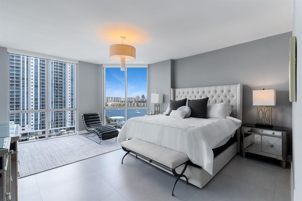 17111 Biscayne Boulevard, Unit 1101 North Miami Beach, FL 33160 - Photo 20 of 43 a spacious bedroom with a bed a couch and dresser