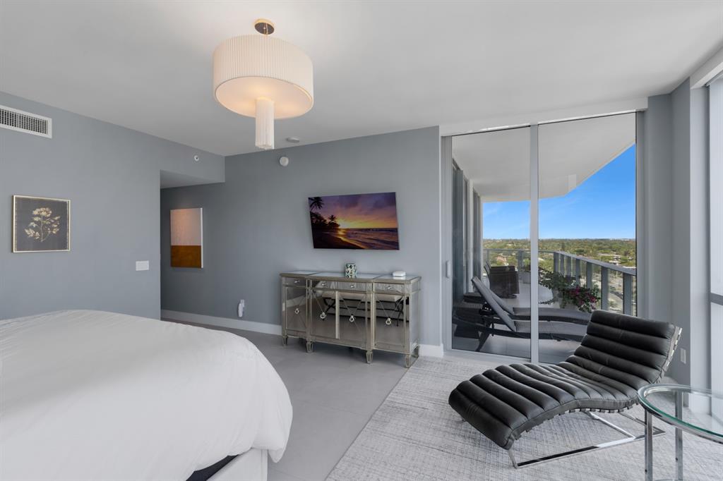 17111 Biscayne Boulevard, Unit 1101 North Miami Beach, FL 33160 - Photo 22 of 43 a bedroom with furniture and a flat screen tv