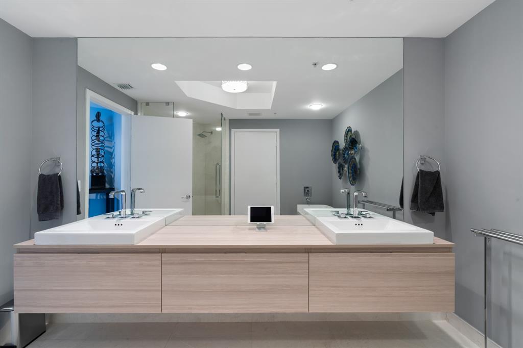 17111 Biscayne Boulevard, Unit 1101 North Miami Beach, FL 33160 - Photo 25 of 43 a bathroom with a double vanity sink and a mirror