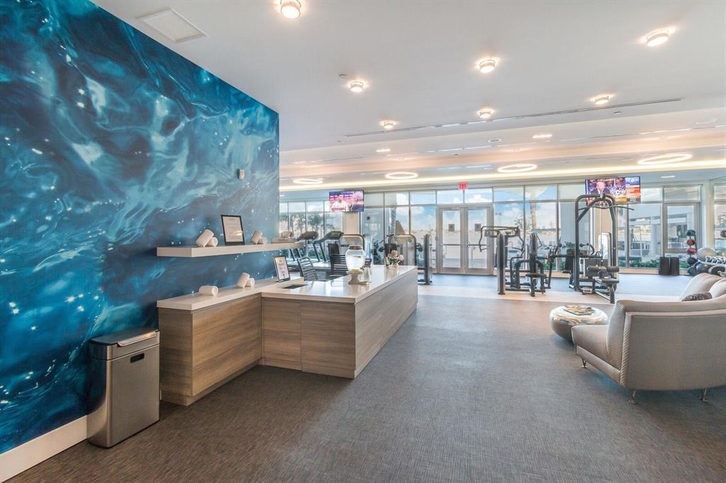 17111 Biscayne Boulevard, Unit 1101 North Miami Beach, FL 33160 - Photo 36 of 43 a large living room with stainless steel appliances with couches a table and chairs