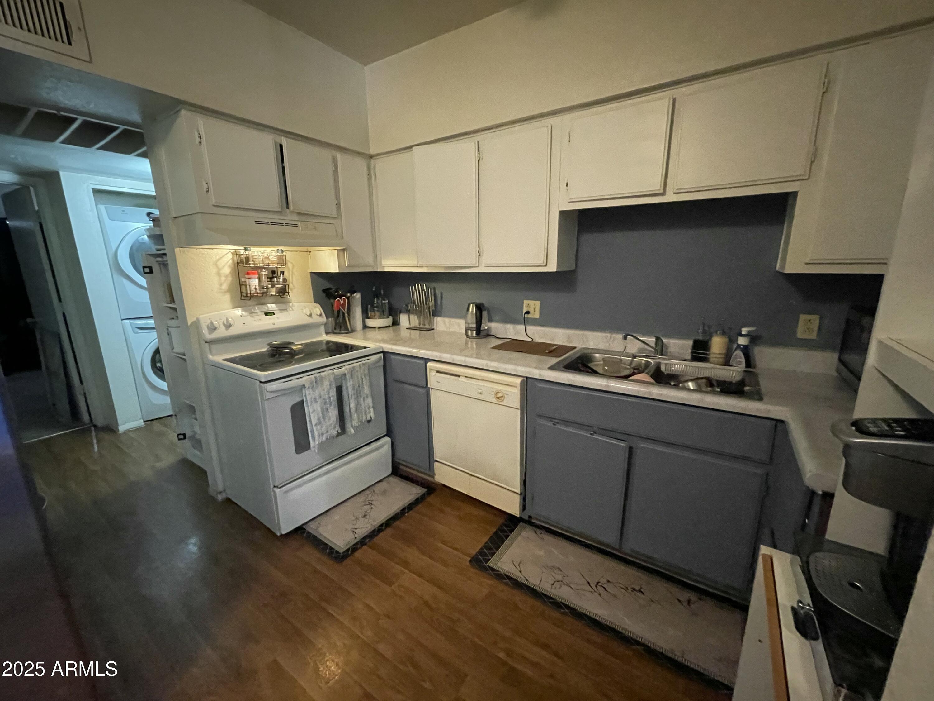 2813 East Monte Cristo Avenue Phoenix, AZ 85032 - Photo 17 of 26 a kitchen with a sink a stove a refrigerator and cabinets