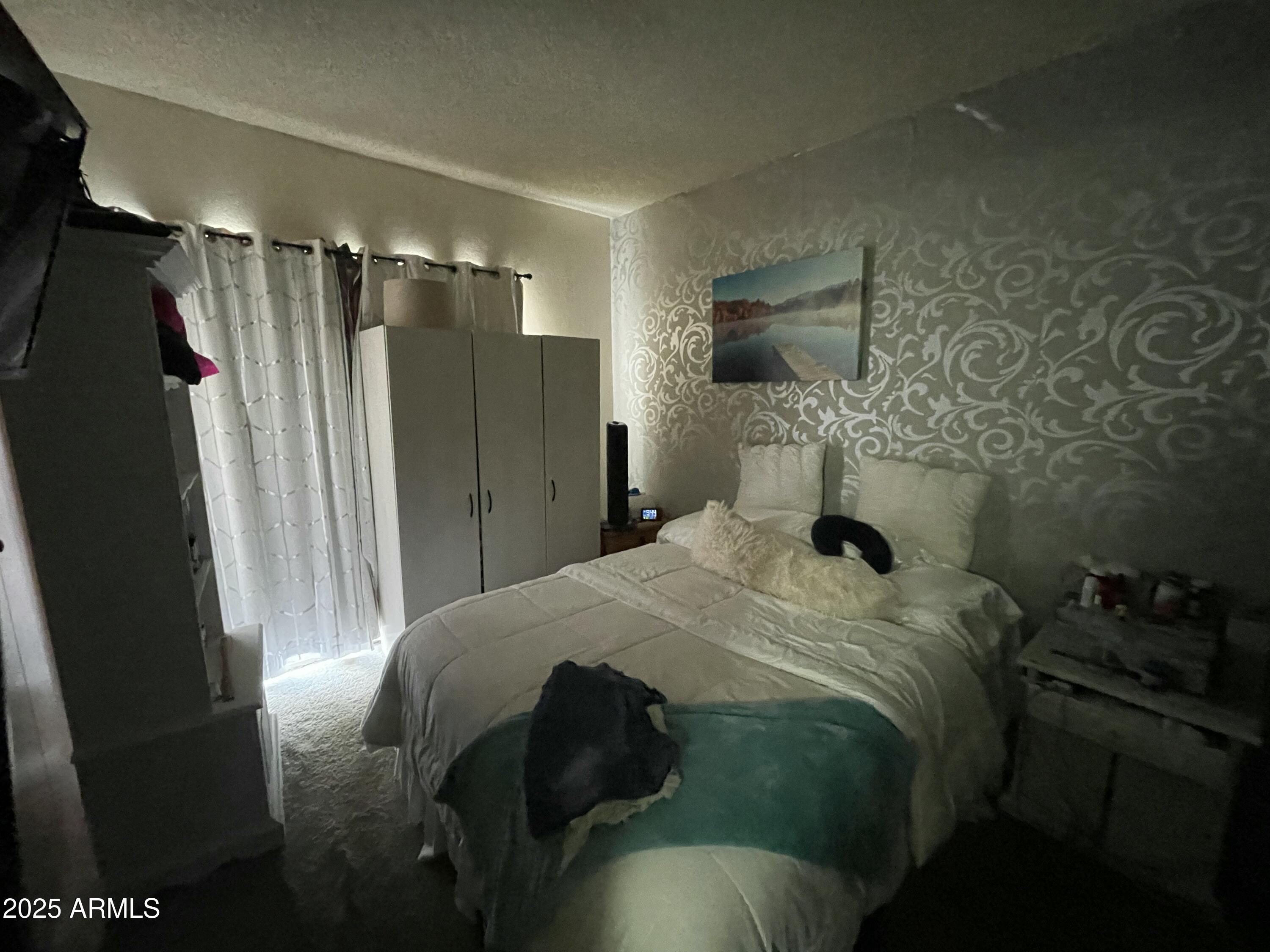 2813 East Monte Cristo Avenue Phoenix, AZ 85032 - Photo 23 of 26 a bedroom with a bed and a flat tv screen