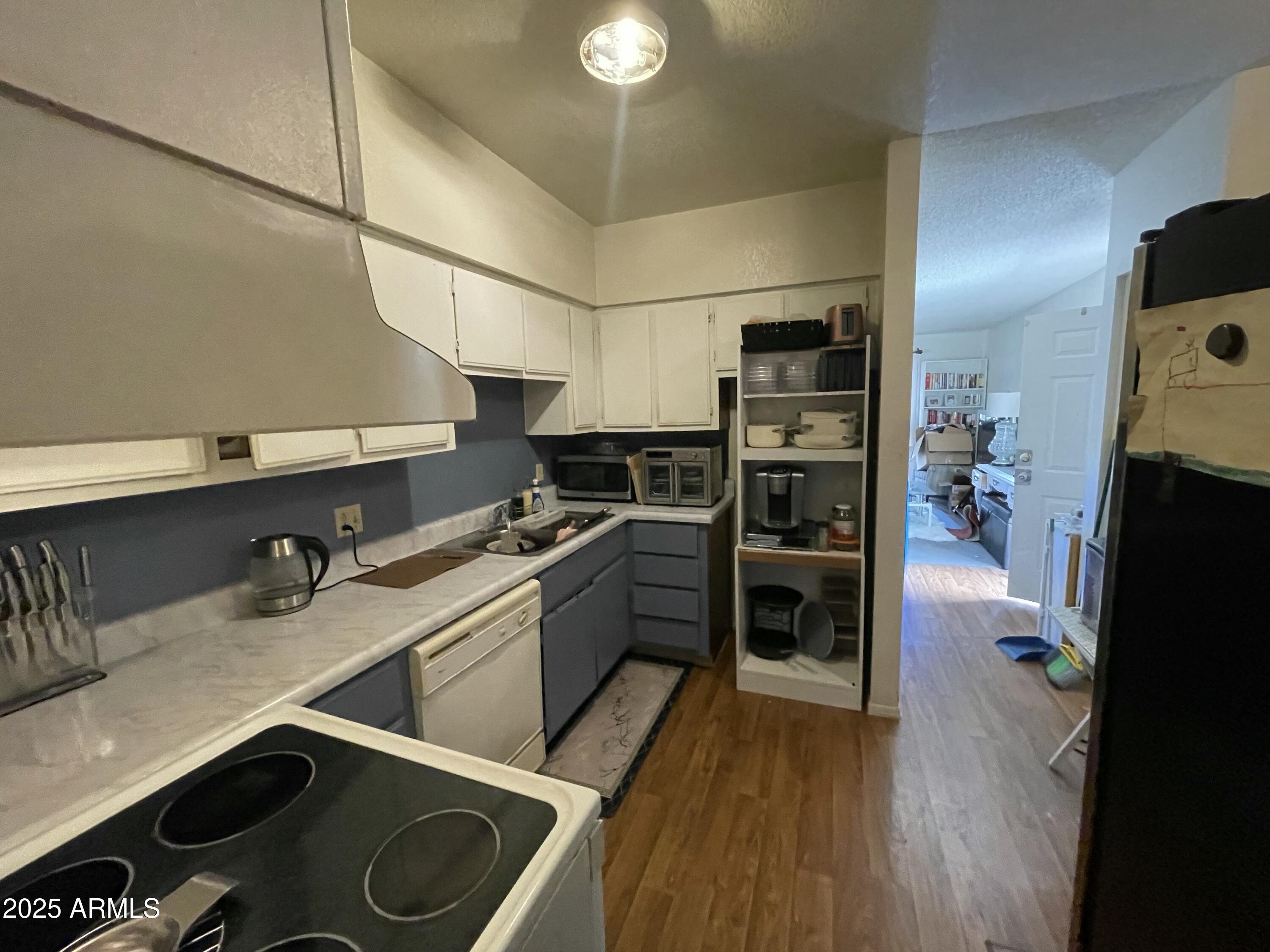 2813 East Monte Cristo Avenue Phoenix, AZ 85032 - Photo 26 of 26 a kitchen with a refrigerator and a stove top oven