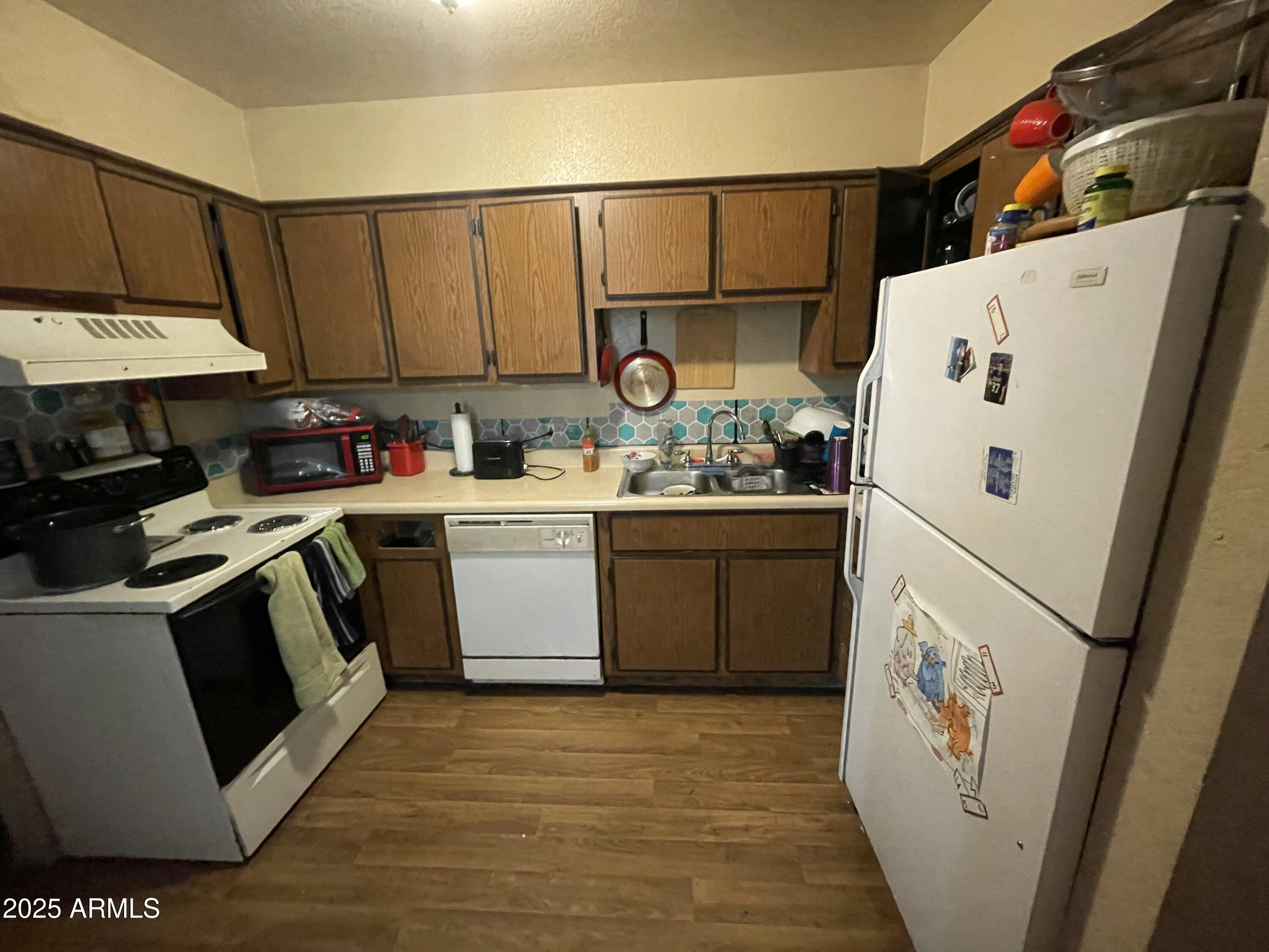 2813 East Monte Cristo Avenue Phoenix, AZ 85032 - Photo 10 of 26 a white refrigerator freezer sitting inside of a kitchen