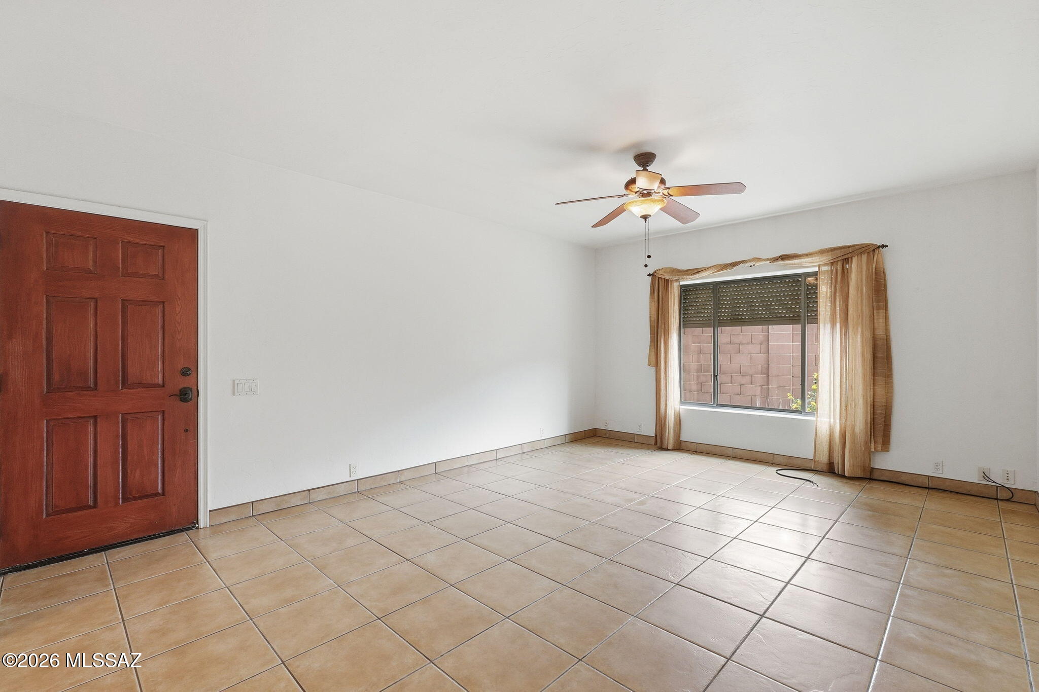 1125 East Kleindale Road Tucson, AZ 85719 - Photo 32 of 49 a view of an empty room with a ceiling fan and window