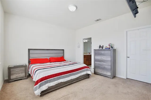 a room with a bed and dresser