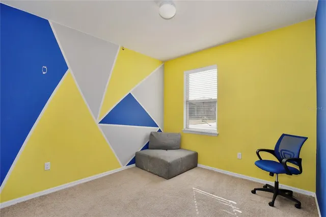 a living room with a couch and piano table